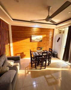 a dining room with a table and a couch at Bungalow o apartamento de 1 Habitación con Piscina Para Parejas in Las Terrenas