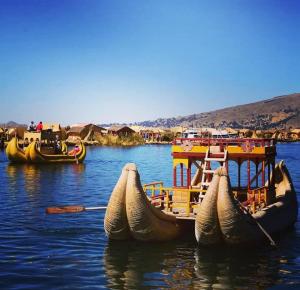 a group of boats sitting in the water at Andenes Perú in Puno