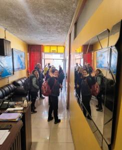 a group of people standing in front of a mirror at Andenes Perú in Puno