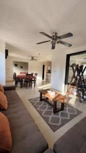 a living room with a couch and a table at Home 365 Mérida Comodidad, amplitud total, 3 recamaras, 2 baños 5 camas ideal familias Consulado Americano in Mérida +33 photos