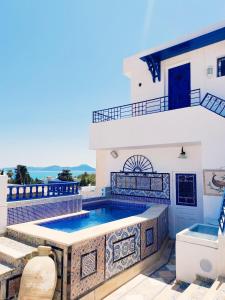 a swimming pool on the roof of a house at House Near the Sky in Dar Salah Bey