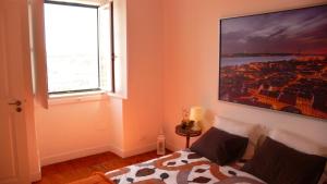 a bedroom with a bed and a large window at Apartment terrace Castelo S.Jorge in Lisbon