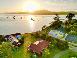 an aerial view of a lake with boats in the water at Waterfront Casilda Guesthouse in Dunalley