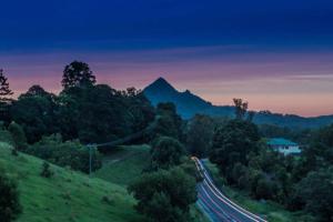 a road in the hills with a mountain in the background at Mini Mullum Studio Retreat in Mullumbimby +6 photos