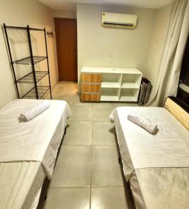 a room with two beds in a room at Salt Beach Atalaia Fort do Farol in Salinópolis