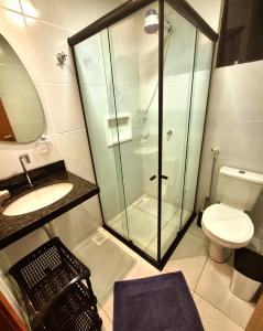 a bathroom with a glass shower and a toilet at Salt Beach Atalaia Fort do Farol in Salinópolis