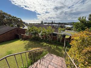 a view of a yard with a fence at Seaview Townhouse 2 - Bring your own linen. in South West Rocks
