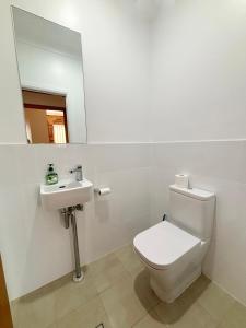 a bathroom with a white toilet and a sink at Seaview Townhouse 2 - Bring your own linen. in South West Rocks +12 photos