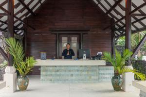 a man standing at a desk in a house at Chads Dive Resort Lembeh in Bitung +71 photos