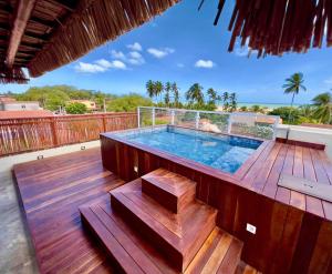 a deck with a plunge pool on top of a house at Pousada Ybitu in São Miguel do Gostoso