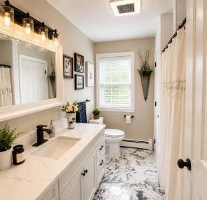 a white bathroom with a sink and a toilet at CrazyHart PVD in Providence