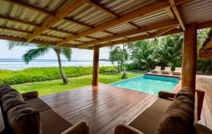a patio with a swimming pool and a wooden deck at Marbella Mentawai Beachfront Private Villa Sleeps 10 in Katiet +32 photos