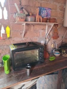 a microwave sitting on top of a wooden table at casa domo in Maimará