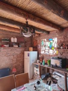 a kitchen with a refrigerator and a table with chairs at casa domo in Maimará