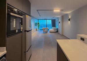 a kitchen with a counter and a living room at Panoramic Nile View 3BR Apartment in Cairo