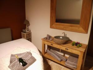 a bathroom with a sink on a wooden table at Relax Garden in Hulshout