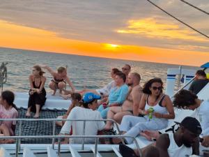 a group of people sitting on a boat in the ocean at Balade de 3 heures en Catamaran de Luxe djerba in Houmt Souk