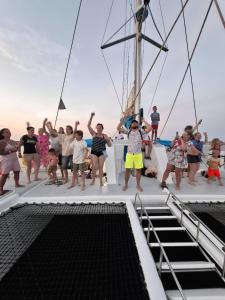 a group of people standing on a boat at Balade de 3 heures en Catamaran de Luxe djerba in Houmt Souk