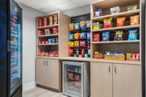 a store room with a refrigerator and shelves with food at City Express By Marriott Findlay in Findlay +4 photos