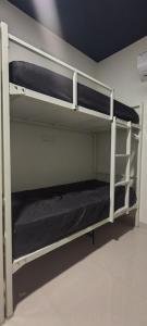 a couple of bunk beds in a room at Thuyil Inn Koodal in Madurai +5 photos