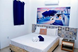 a bedroom with a bed with a picture on the wall at La Suite Praia Hotel in Caucaia +99 photos