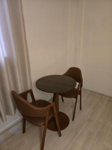 a table and two chairs in a room at 지슬스테이 in Pyoseon
