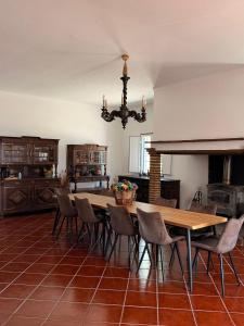 a large kitchen with a wooden table and chairs at Herdade do Corval in Reguengos de Monsaraz