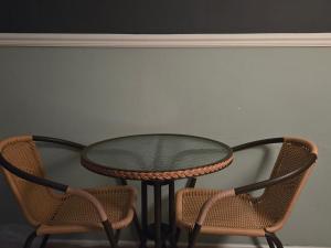 a table and two chairs with a glass table and two chairs at 지슬스테이 in Pyoseon +3 photos