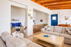 a living room with two couches and a table at Villa Seashell in Pefki