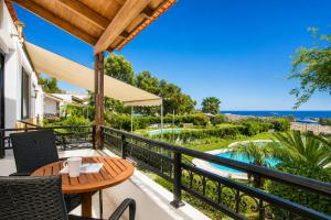 a balcony with a table and chairs and a view of the ocean at Villa Seashell in Pefki