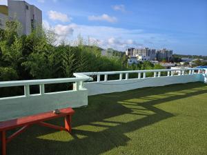 a white fence sitting on top of a green field at 지슬스테이 in Pyoseon