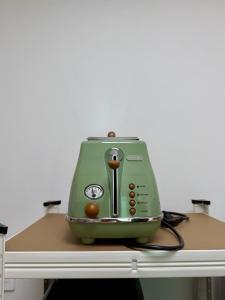 a green toaster sitting on top of a table at 1&2 Stay in Daegu
