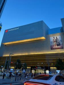 a large building with people walking in front of it at 1&2 Stay in Daegu