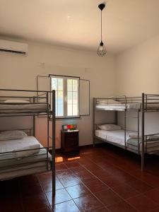 a room with three bunk beds and a window at Herdade do Corval in Reguengos de Monsaraz +19 photos