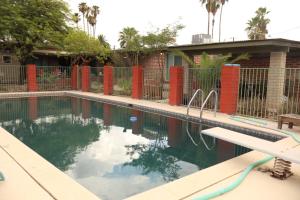 a swimming pool in front of a fence at Dodge Residence in Tucson