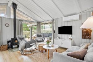 a living room with a couch and a fire place at 440-Hvide-Sande-Strandkrogvejen-60 in Hvide Sande
