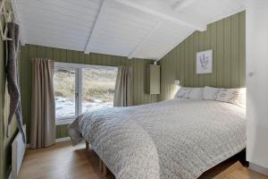 a bedroom with a bed and a window at 440-Hvide-Sande-Strandkrogvejen-60 in Hvide Sande