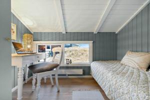 a bedroom with a desk and a bed next to a window at 440-Hvide-Sande-Strandkrogvejen-60 in Hvide Sande +35 photos
