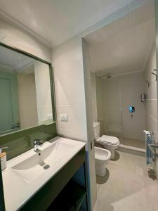 a bathroom with a sink and a toilet at Entre Patios in Azul +51 photos