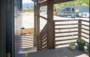 an open door to a porch with a wooden fence at Nice Apartment In Rysstad With Wifi in Rysstad