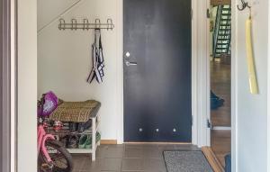 a hallway with a black door and a bike at Nice Apartment In Rysstad With Wifi in Rysstad +6 photos