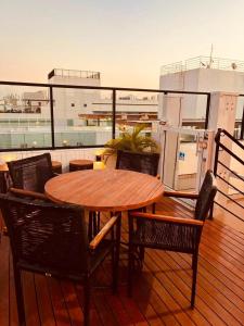 a wooden table and chairs on the deck of a ship at Get By Side na Beira mar do Caribessa Jardim Oceania in João Pessoa