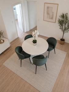 a white table and chairs in a room at Élégant stays in Vilvoorde