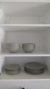 a row of plates on a shelf in a refrigerator at Élégant stays in Vilvoorde +1 photo