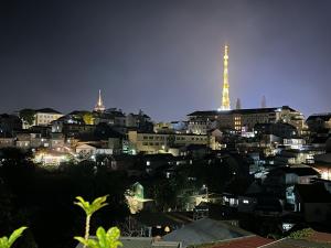 a view of a city at night with a tower at S79 Hoa Dang Dalat in Da Lat