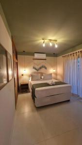 a bedroom with a large bed in a room at Brisas do Amor Apartamentos com jacuzzi privativa in Pipa +69 photos
