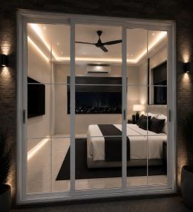a bedroom with a bed and a ceiling fan at Prince Villa in Neral