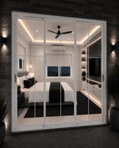 a bedroom with a bed and a large window at Prince Villa in Neral