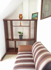 a living room with a couch and a shelf at City Lavish in Nuwara Eliya