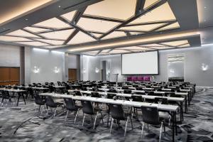 a conference room with tables and chairs and a screen at W Bellevue in Bellevue